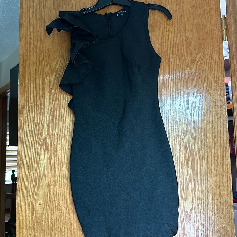 Gorgeous bodycon bandage cocktail dress with ruffle detail on shoulder.